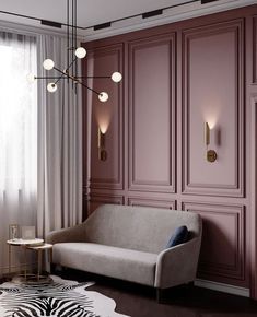 a living room with pink walls and zebra print rugs on the floor next to a couch