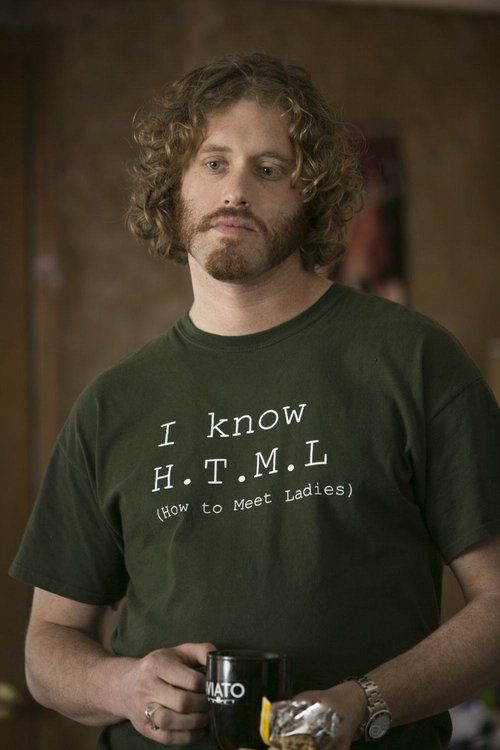 a man with curly hair wearing a green t - shirt that says i know ht m l how to meet ladies