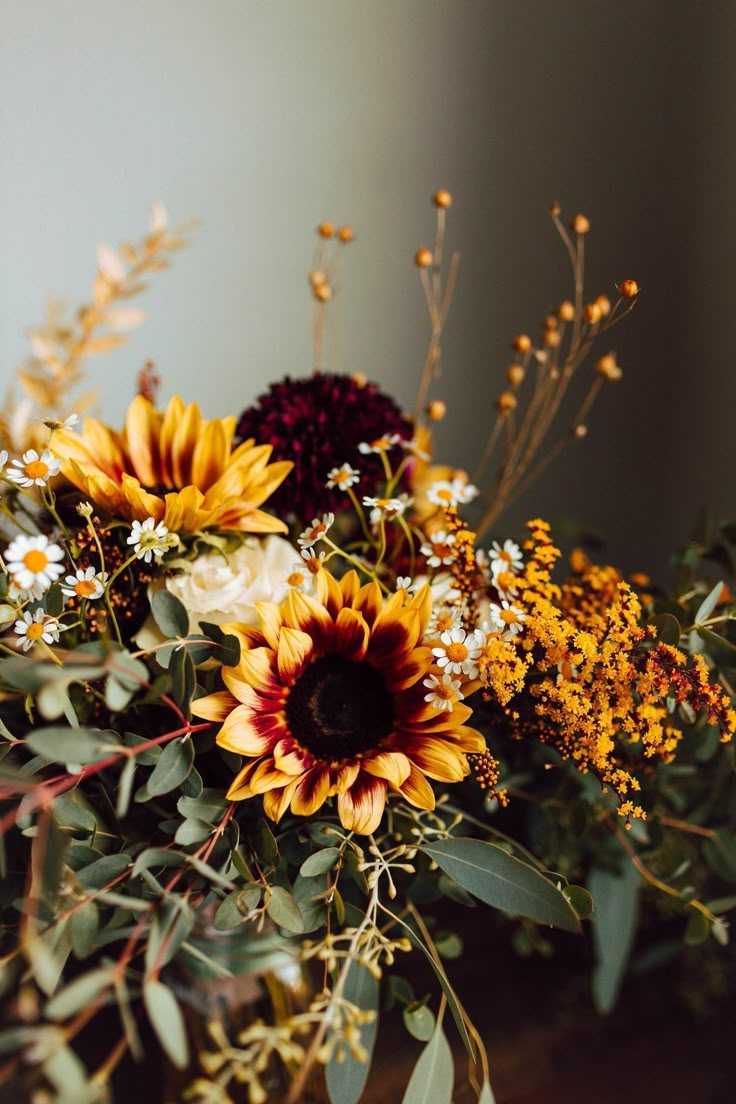 a vase filled with lots of different types of flowers