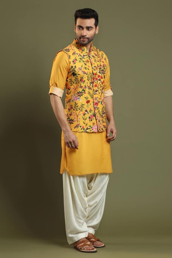 Marigold yellow bundi with floral, bird print and tab sleeves. Paired with pleated salwar and kurta.
Component: 3
Pattern: Printed
Type Of Work: Floral,Bird
Neckline: Band
Sleeve Type: Tab Sleeves
Fabric: Silk Blend
Color: Yellow
Other Details: 
Printed bundi
Tab sleeves
Occasion: Destination Wedding - Aza Fashions Pleated Salwar, Kurta Set For Men, Marigold Yellow, Types Of Work, Yellow Silk, Bird Print, Fabric Silk, Kurta Set, Bird Prints