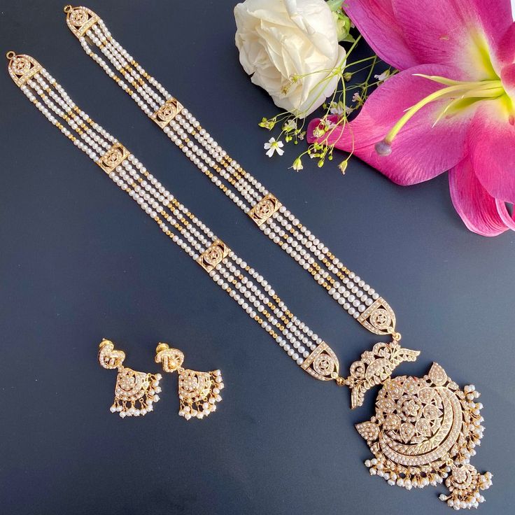 Featuring a 22k gold jadau rani haar set in all pearls. The necklace weighs 73.35 gms including 2.30 gms in the hanging beads and 23.25 gms in the 4 lines of pearls strings. The earrings weigh 10.75 gms including 1.15 gms in the hanging pearl beads 22k Gold Jewelry Necklaces, Long Necklace Set, Rani Haar, 22k Gold Jewelry, Hanging Beads, Pearl Necklace Set, Gold Jewelry Necklace, Emerald Necklace, Gold Bangle Bracelet