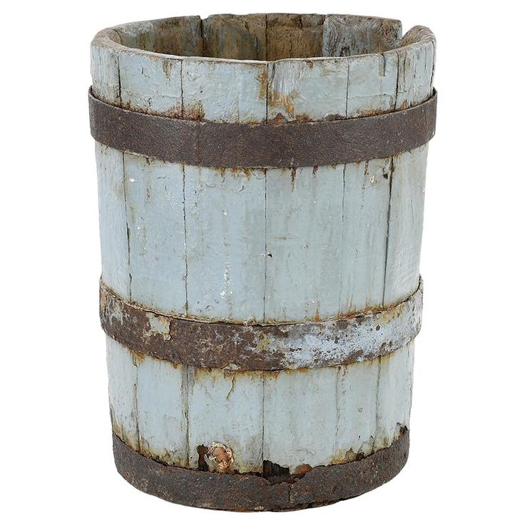 an old wooden bucket with rusted metal straps on the bottom and sides, isolated against a white background