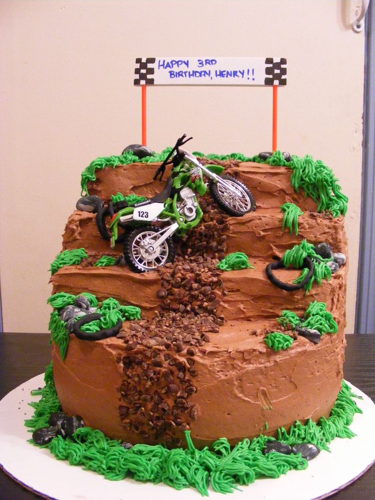 a birthday cake is decorated with dirt bikes