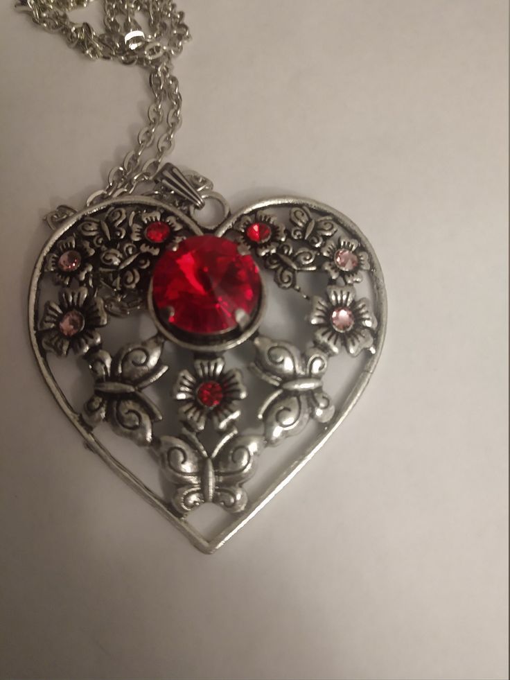 Antique silver heart with red Swarovski crystals Heart-shaped Jeweled Jewelry Gift, Heart-shaped Jeweled Jewelry For Gift, Heart Shaped Jeweled Jewelry For Gift, Silver Heart Cut Metal Jewelry, Silver Metal Jewelry With Heart Cut, Silver Heart Necklace For Valentine's Day Formal, Silver Heart Necklace For Valentine's Day And Formal Events, Silver Heart Jewelry With Bling, Silver Metal Heart Cut Jewelry