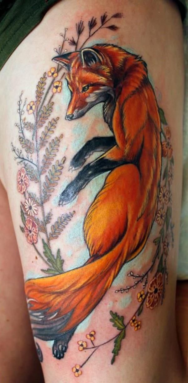 a woman's thigh with an orange fox tattoo on her leg and flowers in the background