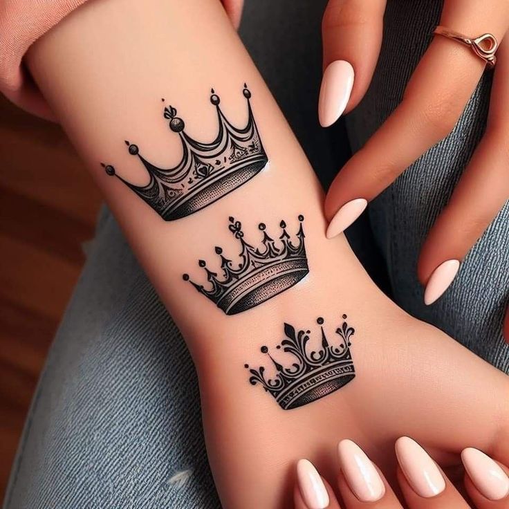 a woman's foot with tattoos on it and a crown tattooed on the wrist