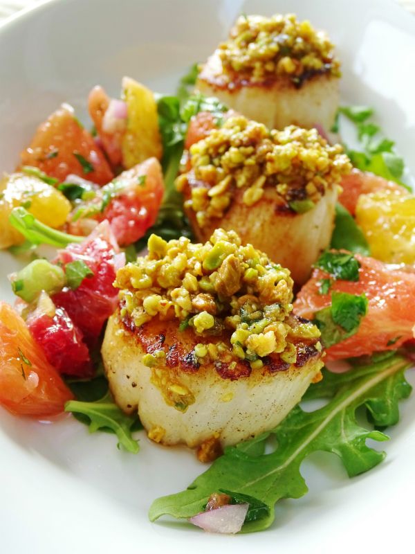 seared scallops on a bed of greens and tomatoes