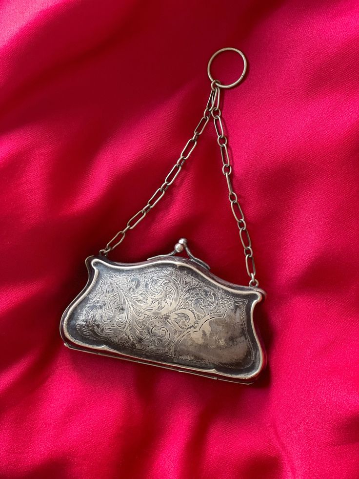 Here we have an Edwardian silver purse in a pretty good condition, fairly spacious inside( room for some small make up and credit card ). Inside lining is blue fabric, There are some stains on it, some signs of repairs. it locks properly, chain is long enough to hold in your hand or have it on your wrist. There are carved tapestry at the front, back in blank. There is a big dip in the back that may have happened many years ago. Item is for sale as is.  Measurements  4 to 3  2.5  Shipping outside USA and Canada has additional fee It's Locked, Silver Purse, Beaded Cardigan, Bohemian Accessories, Vintage Suits, Sequin Sweater, Edwardian Era, Birthday Wishlist, Hand Bags