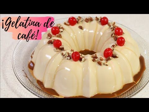 a cake with white frosting and cherries on top sitting on a glass plate