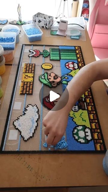 a child is playing with some legos on the table and it looks like he's doing something