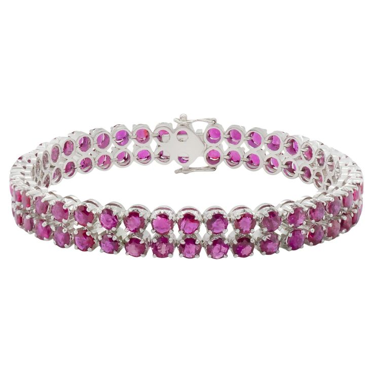 A charming white gold and ruby tennis bracelet. This two row prong set ruby bracelet is perfectly aligned to create a bold yet delicate piece of jewelry. Ruby 82 pcs Size 4.0 mm Total 27.88 cts Length: 7.2 inch Height: 8mm Jewelry Ruby, Retro Bracelet, Bracelet Tennis, Ruby Bracelet, Tennis Bracelet, Prong Setting, Ruby, Jewelry Bracelets, Tennis