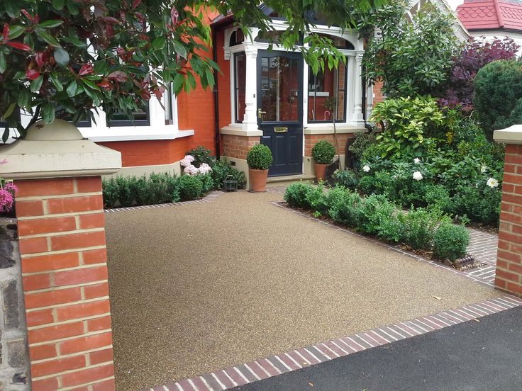 a brick house with landscaping around it