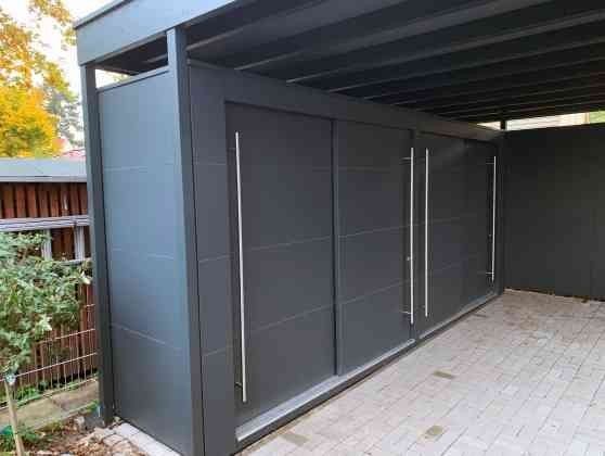 an outdoor covered area with sliding doors on the side and brick flooring around it