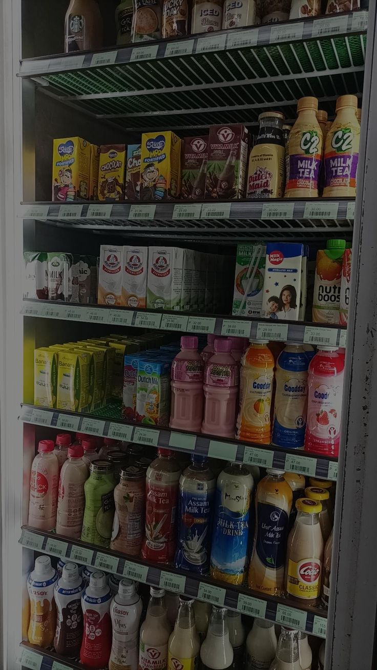 a refrigerator filled with lots of different types of juices and drinks in it's shelves