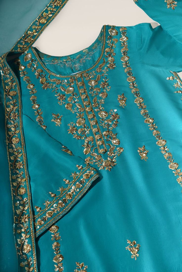 Meticulously crafted from a remarkably glamourous shade of emerald green ( pure raw silk ) with its intricate hand work details on gold and antique strike the perfect balance between elegant and eye-catching, making this beautiful design a must have. The length of the long kameez is 48 inches. Styled with an embellishe Long Kameez, Suits Design, Embroidery Suits Design, Organza Dupatta, Embroidery Suits, Hand Work, Bridal Designs, Wedding Wear, Formal Wedding