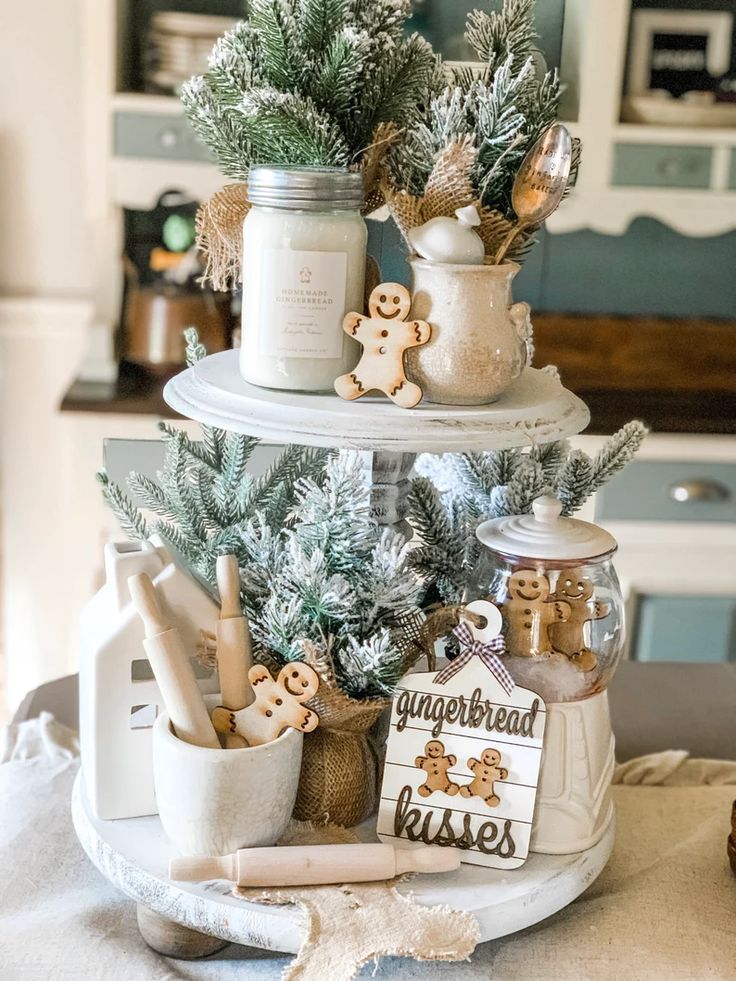 three tiered christmas tree with gingerbread cookies in jars on top and other decorations