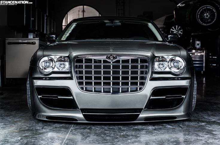 the front end of a silver car in a garage