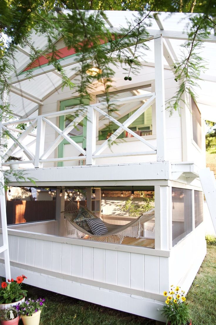 a white house with a porch and balcony