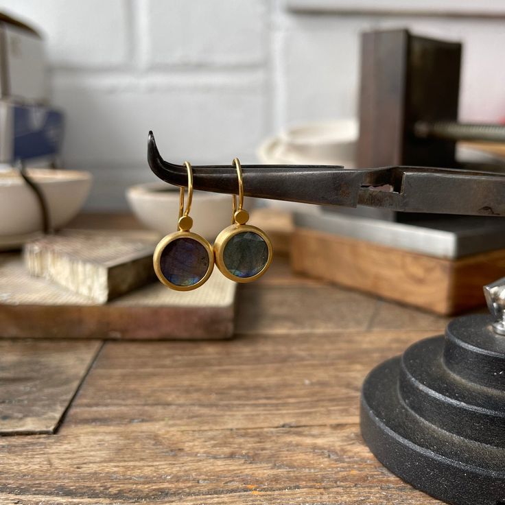 ROUND LABRADORITE HANGING EARRINGS SET IN 22K GOLD, 8.72 CARAT • DESIGNED AND HAND FORGED IN NEW YORK Please email info@elihalili.com or call the shop at 212-941-7979 for any inquiries. Labradorite Earrings, Garnet Earrings, Ruby Earrings, Ancient Coins, Hanging Earrings, Gold Drop Earrings, Rose Cut Diamond, 22k Gold, Hand Forged