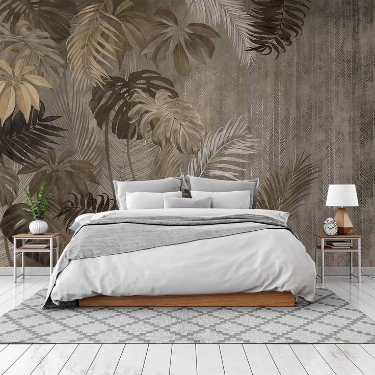 a bedroom with a bed, nightstands and wallpaper that has palm leaves on it