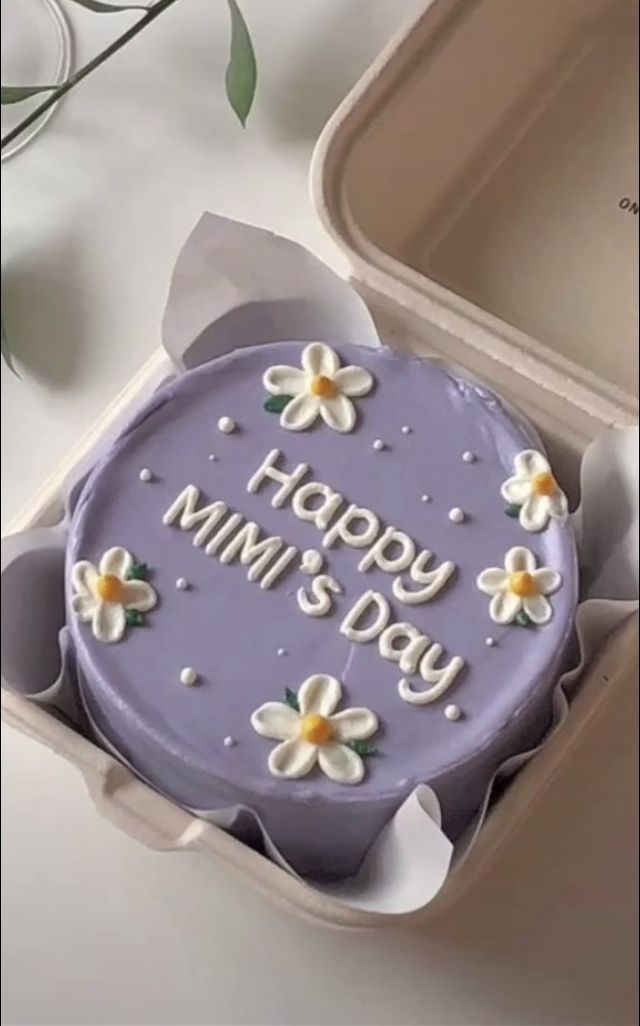 a cake in a box with the words happy day written on it