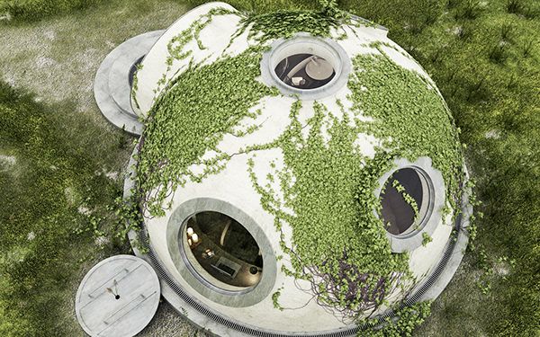 an aerial view of a round building with plants growing on the outside and inside it