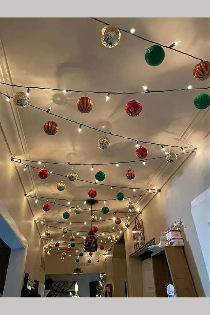 the ceiling is decorated with christmas lights and ornaments