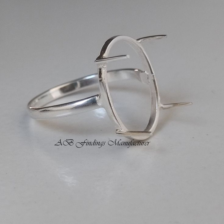 a silver ring sitting on top of a white table