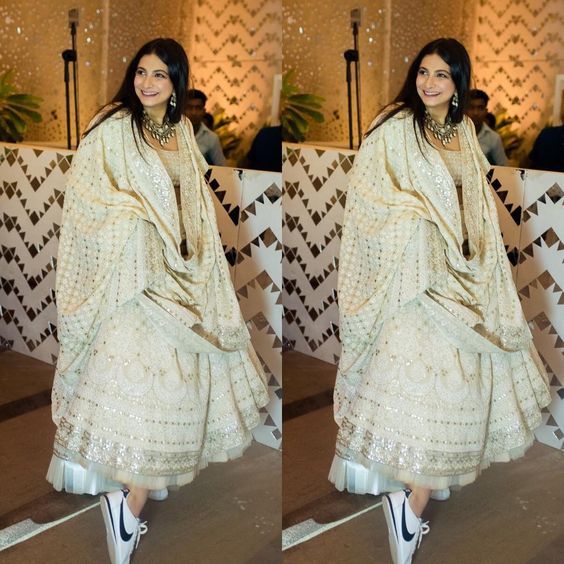 an image of a woman in a white dress and black shoes posing for the camera