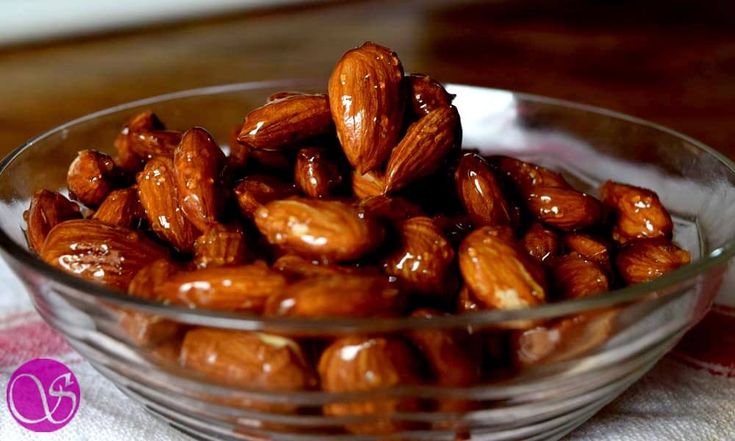 a glass bowl filled with almonds on top of a table