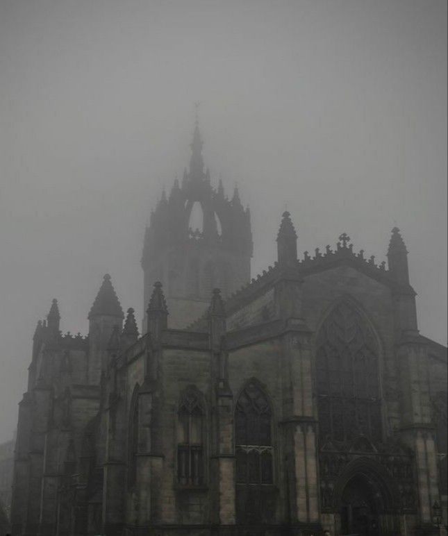 an old gothic church in the fog