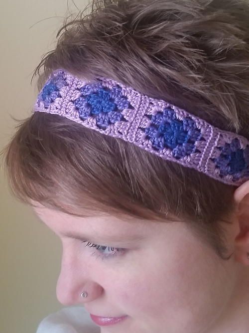 a close up of a person wearing a headband with flowers on it's side