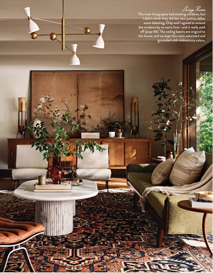 a living room filled with furniture and lots of plants in the middle of the room