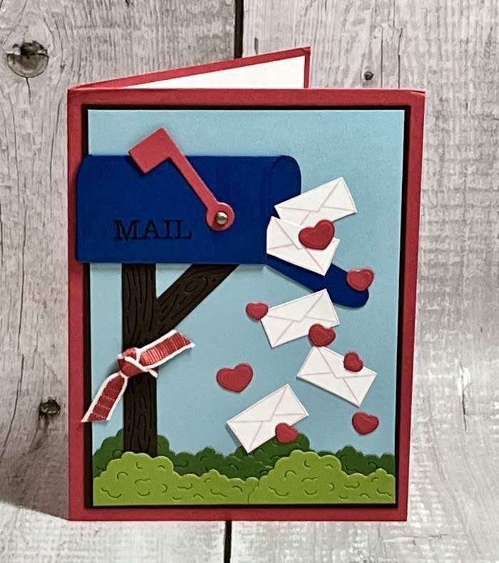 a handmade greeting card with envelopes in the mailbox