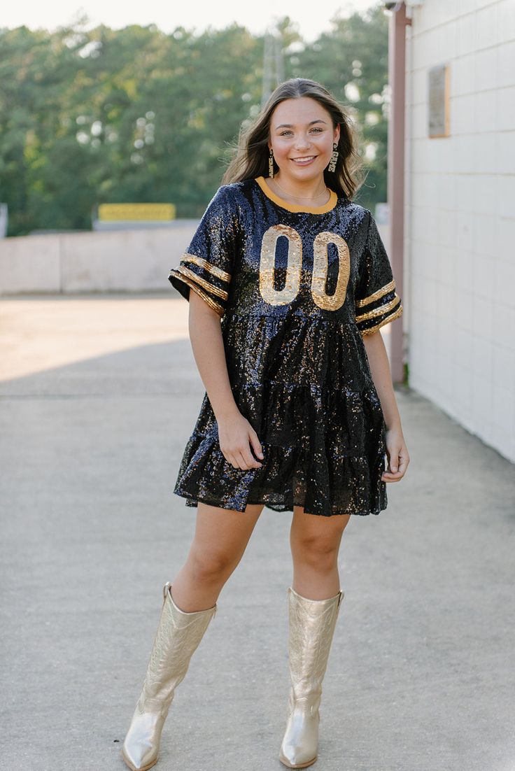 The Black & Gold Jersey Sequin Dress is a dazzling and spirited garment tailored for enthusiastic fans of the New Orleans Saints. This dress is a vibrant celebration of the Saints' iconic black and gold color scheme. The black & gold sequins add a touch of glamour and excitement to the dress, making it a standout choice for game day festivities. model, Jade is wearing a size small Football Outfit, Saints Football, Gold Color Scheme, Gold Outfit, Black Sequin Dress, Football Outfits, Gold Sequins, New Orleans Saints, Sequin Dress