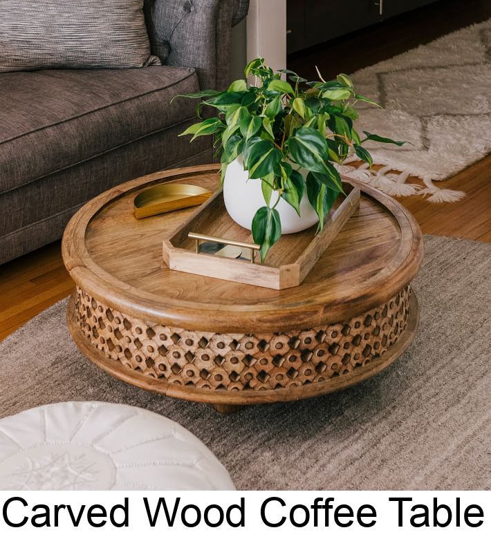 a coffee table with a potted plant on top and the words carved wood coffee table