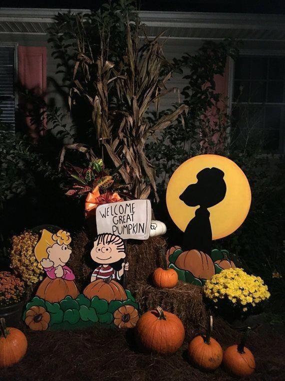 a display with pumpkins and decorations in front of a house that says welcome to the pumpkin patch