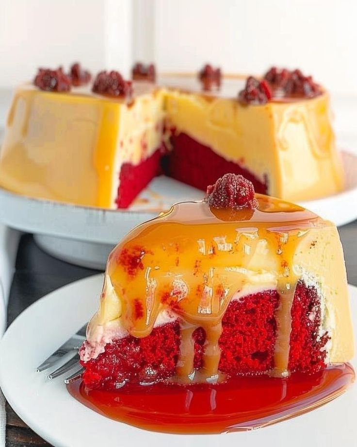 a red velvet cake with white frosting and raspberry toppings on a plate