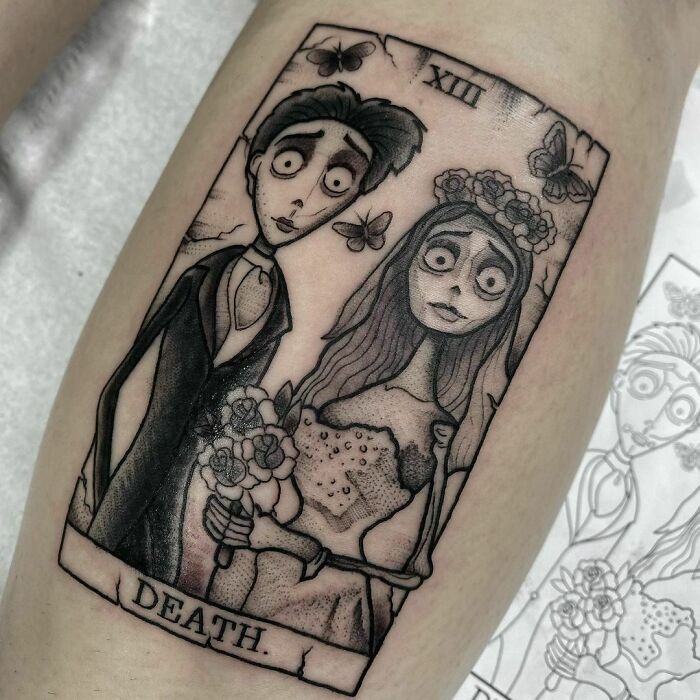 a tattoo on the leg of a man and woman