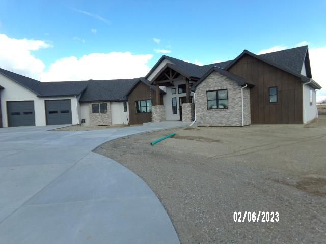 a large house with two garages on each side