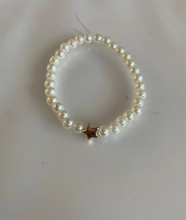 LIMITED TIME ONLY!! Pearl beaded bracelet with gold star (not real gold!) Cheap White Meaningful Beaded Bracelets, Cheap White Dainty Charm Bracelet, Cheap White Heart Bracelets, Cheap White Adjustable Friendship Bracelets, Cheap Heart Beads Bracelet For Birthday, Bracelet With Stars, Gold Bead Bracelet Ideas, Pearl Beads Bracelet Ideas, White Pearl Bracelet Diy