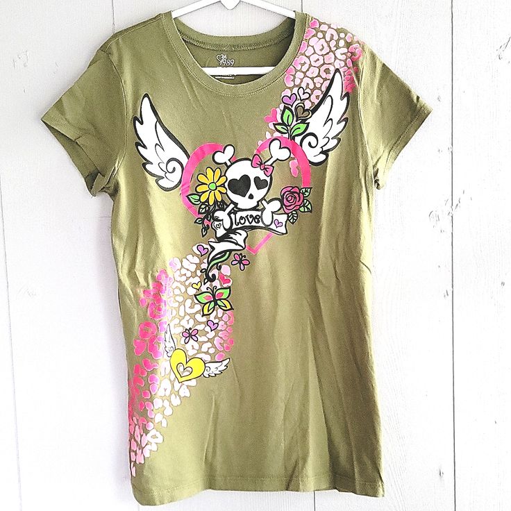 Nwot Green T-Shirt With Skull , Angel Wings, Heart,And Animal Print. Never Been Worn. Skull And Wings Have Glitter On Them. Size L 10/12. Like 2 More Items With A And Get All 3 For $21! Casual Spring T-shirt With Skull Print, Fitted Trendy T-shirt With Skull Print, Spring Skull Print Short Sleeve T-shirt, Spring Short Sleeve T-shirt With Skull Print, Spring Skull Print Graphic Tee, Trendy Cotton Skull Print Tops, Y2k Skull Print Crew Neck T-shirt, Green Skull Print Top For Streetwear, Green Skull Print Tops For Streetwear