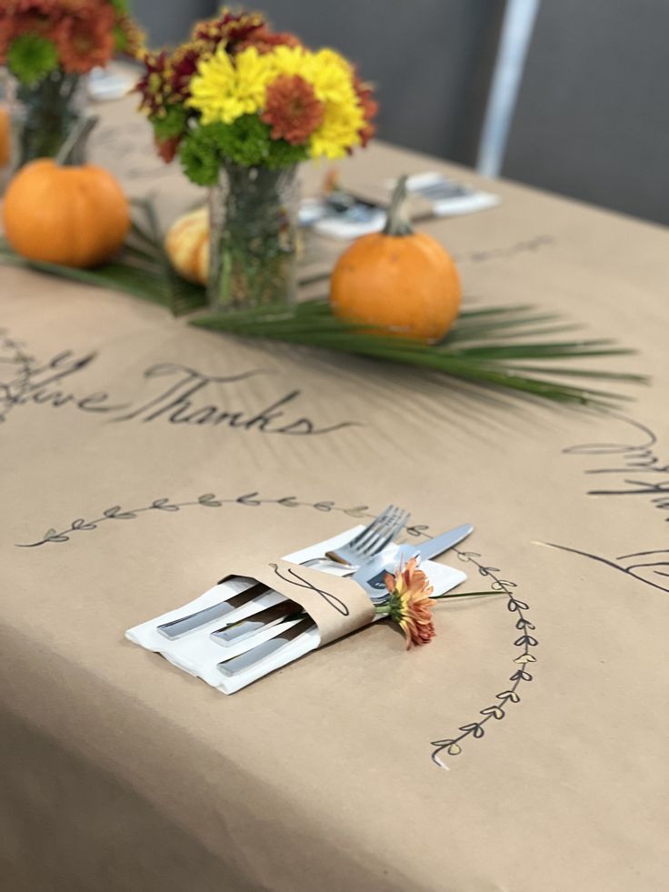 there is a table set with flowers and forks