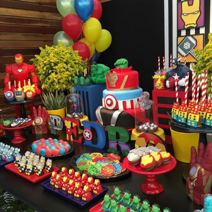 a table topped with lots of cakes and cupcakes