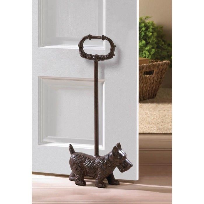 a door handle with a dog figurine next to it on the front door