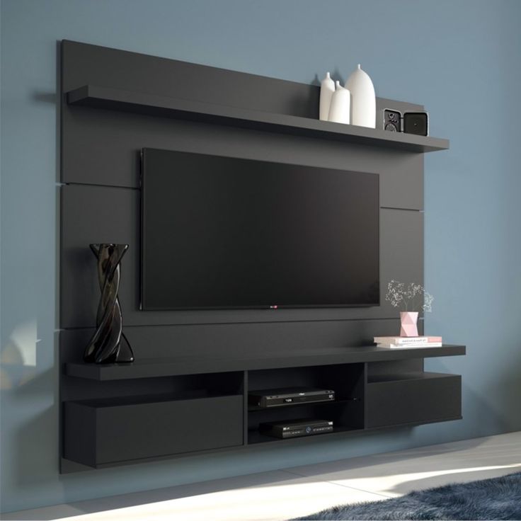 the entertainment center is built into the wall and has shelves on each side that hold various items