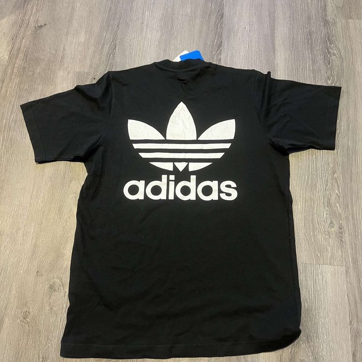 Brand New With Tags, Size M Classic Adidas Cotton Tops, Classic Adidas Short Sleeve Tops, Classic Black Tops With Logo Print, Basic Adidas Tops For Streetwear, Basic Black Shirt With Logo Print, Classic Black Top With Graphic Print, Adidas Casual Tops For Streetwear, Adidas Casual Streetwear Tops, Black Adidas Shirt For Streetwear