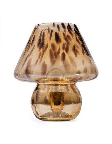 a glass lamp with a brown shade on it's side and a white background