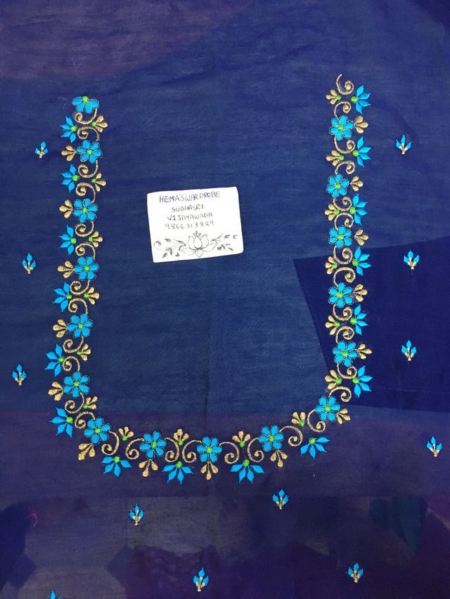 a piece of cloth with blue and yellow flowers on it that has a note attached to it