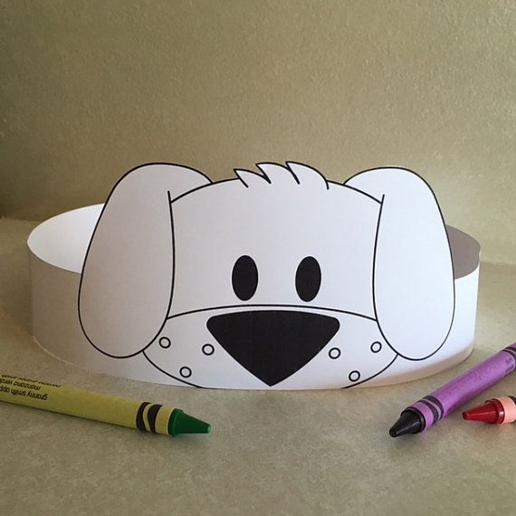 a paper hat with a dog's face on it and crayons next to it